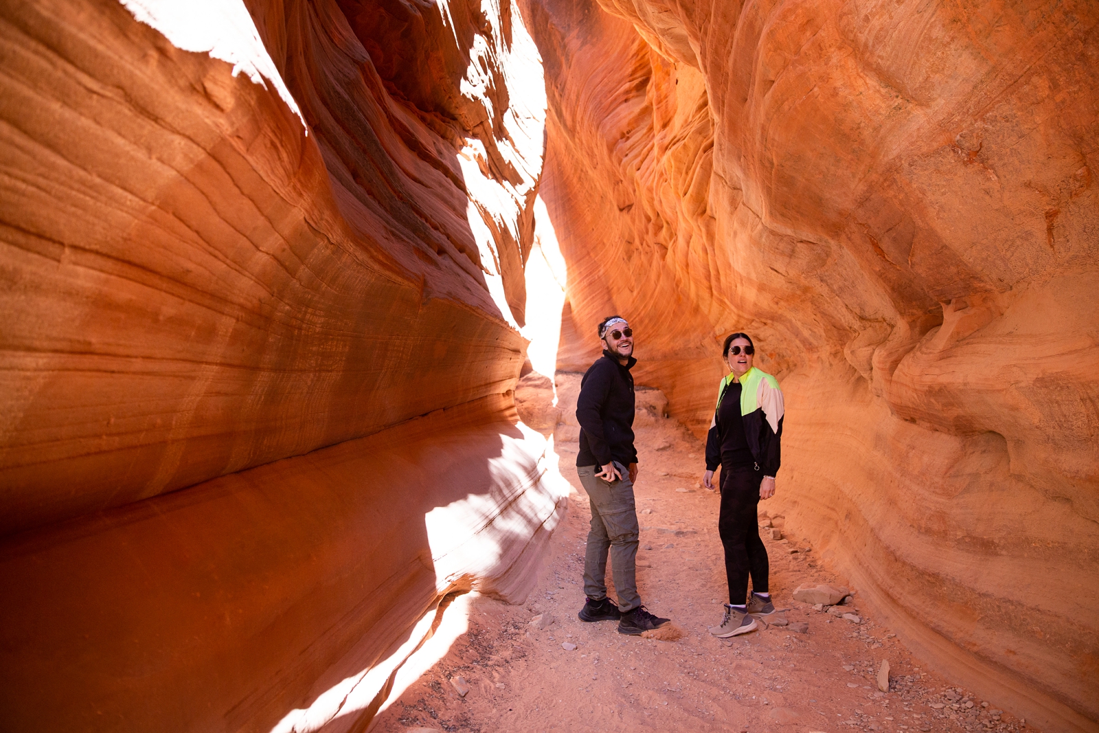 Couple walking through the Utah slot canyon during their hiking adventure through the antelope canyon
