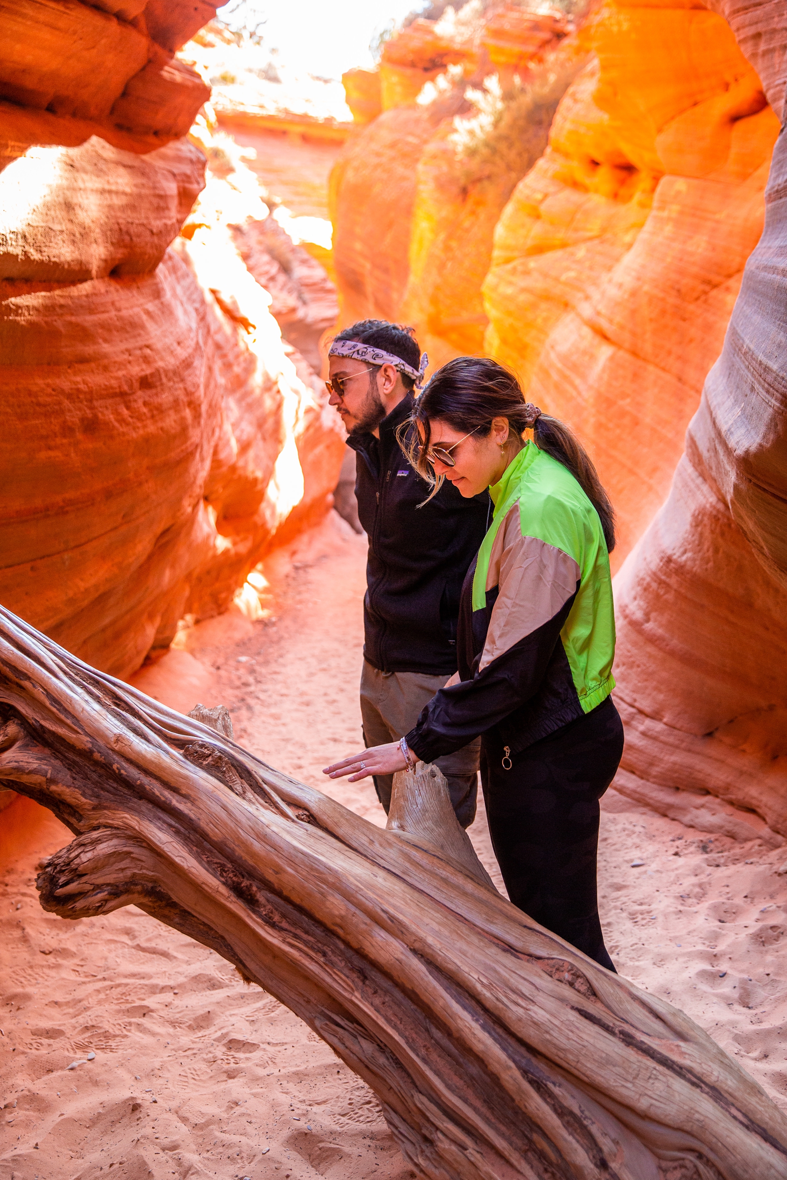 A newly engaged couple admiring the tree in the Utah slot canyon