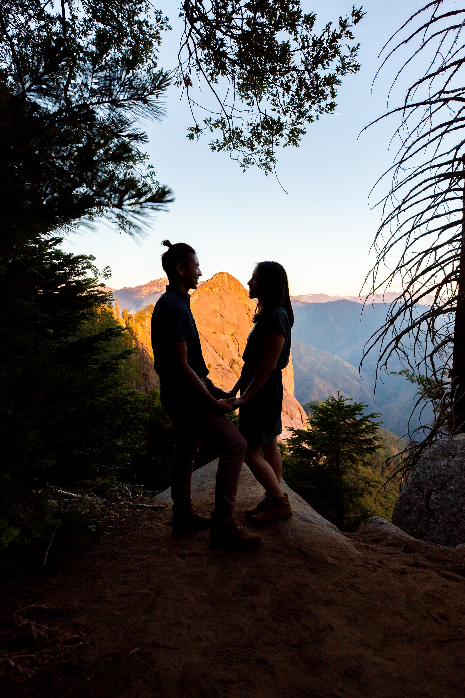 Silhouetted engaged couple in front of Morro Rock in Sequoia National Park.