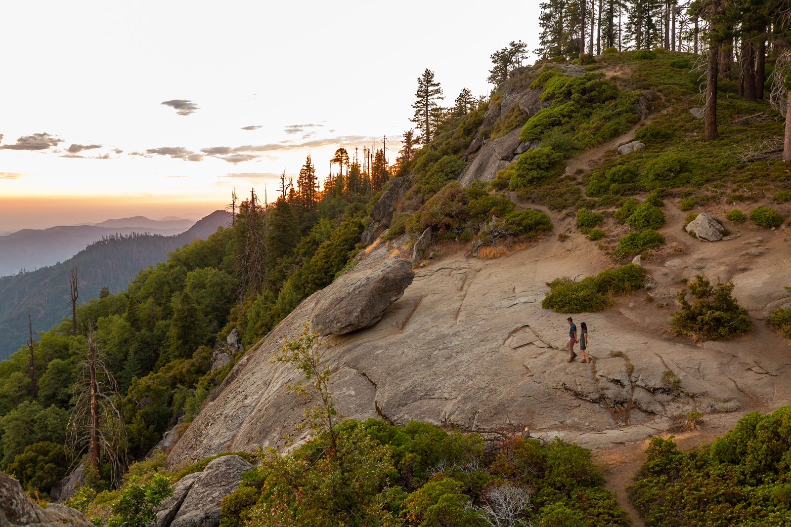 Couple hiking on a cliff at their Sequoia National Park engagement Session.