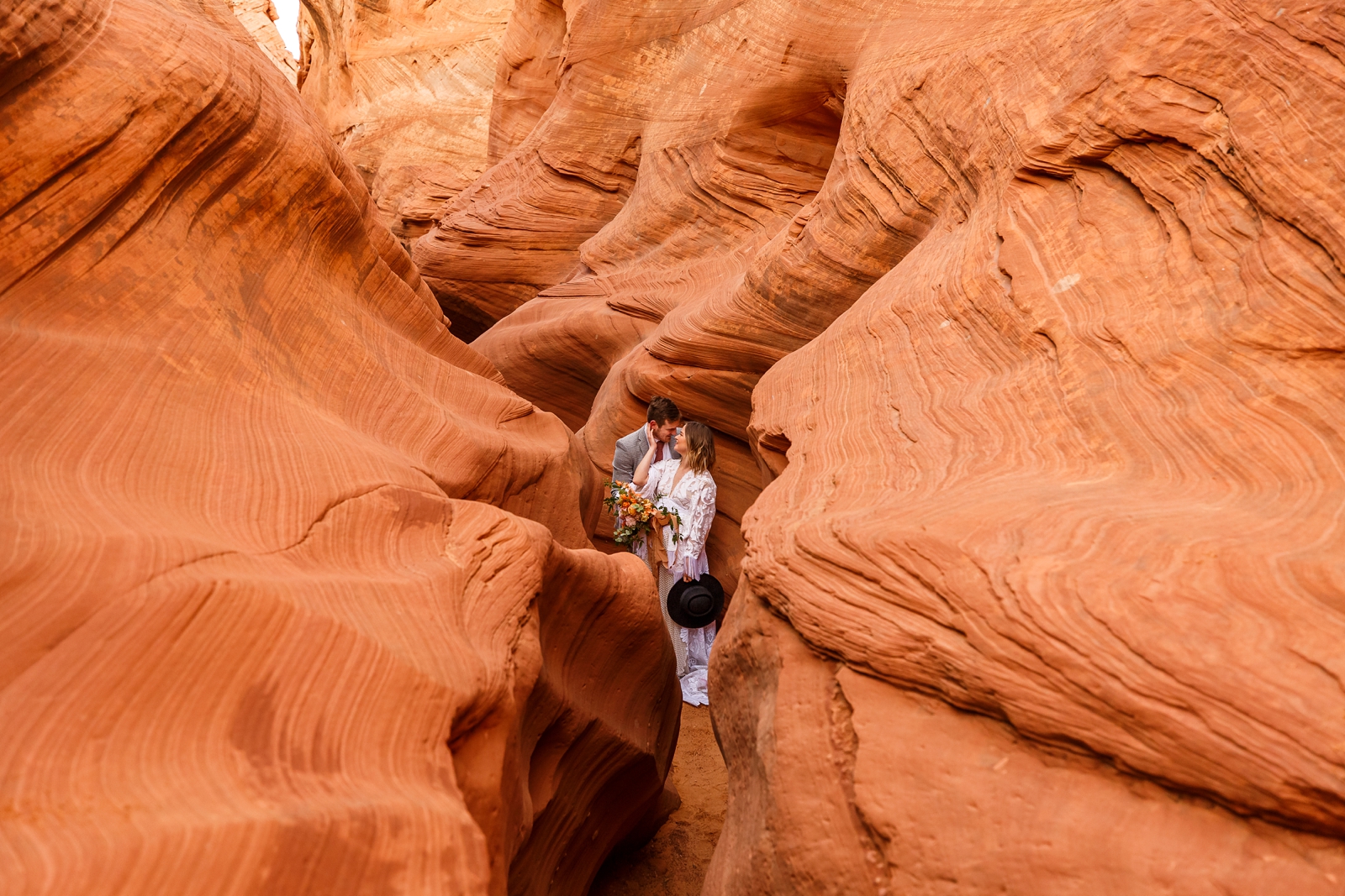 This fun boho in-love couple traveled to Page Arizona for their adventurous slot canyon elopement at Waterholes Canyon
