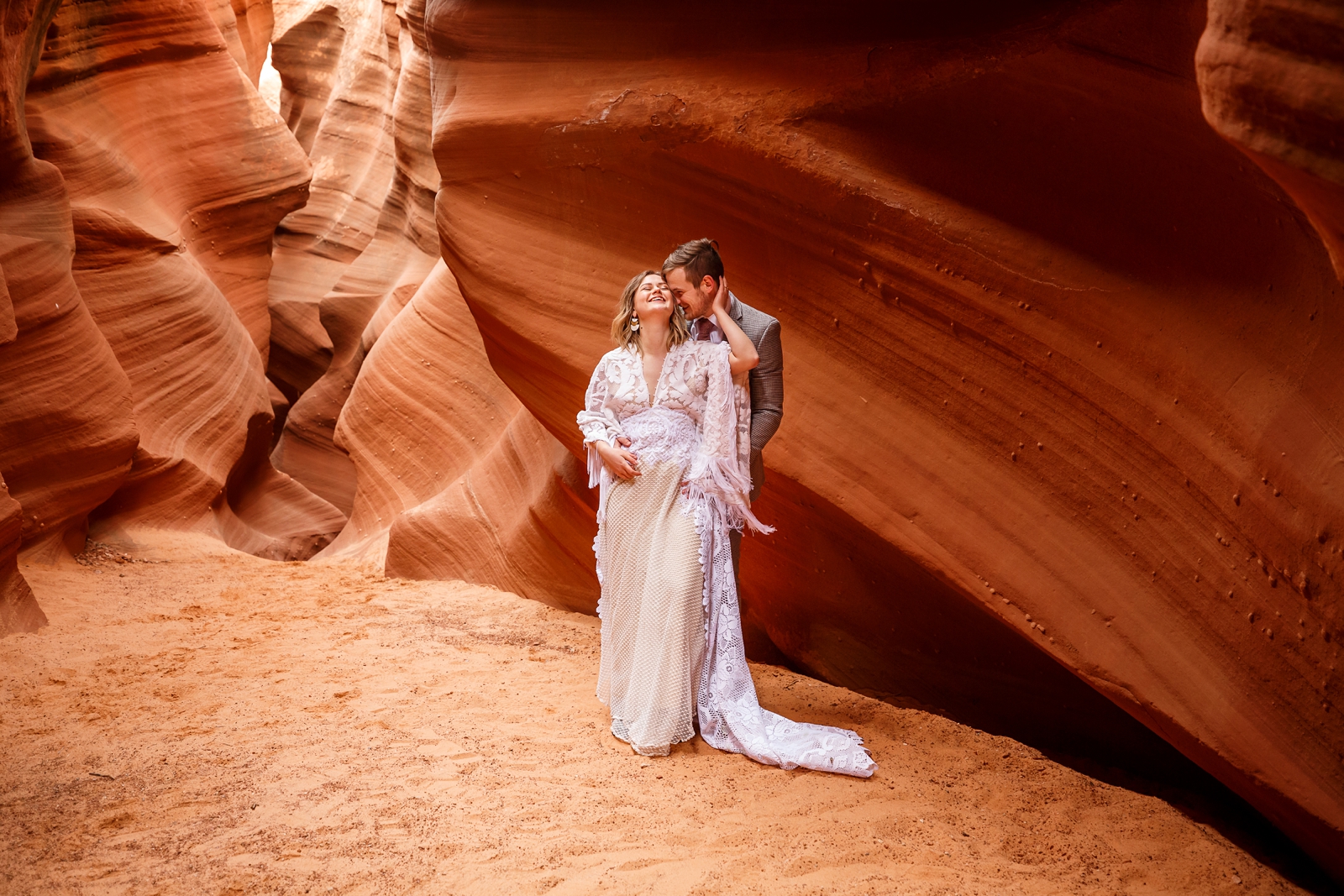 A fun boho couple enjoying their slot canyon elopement in Waterholes Canyon near Horseshoe Bend in Page Arizona