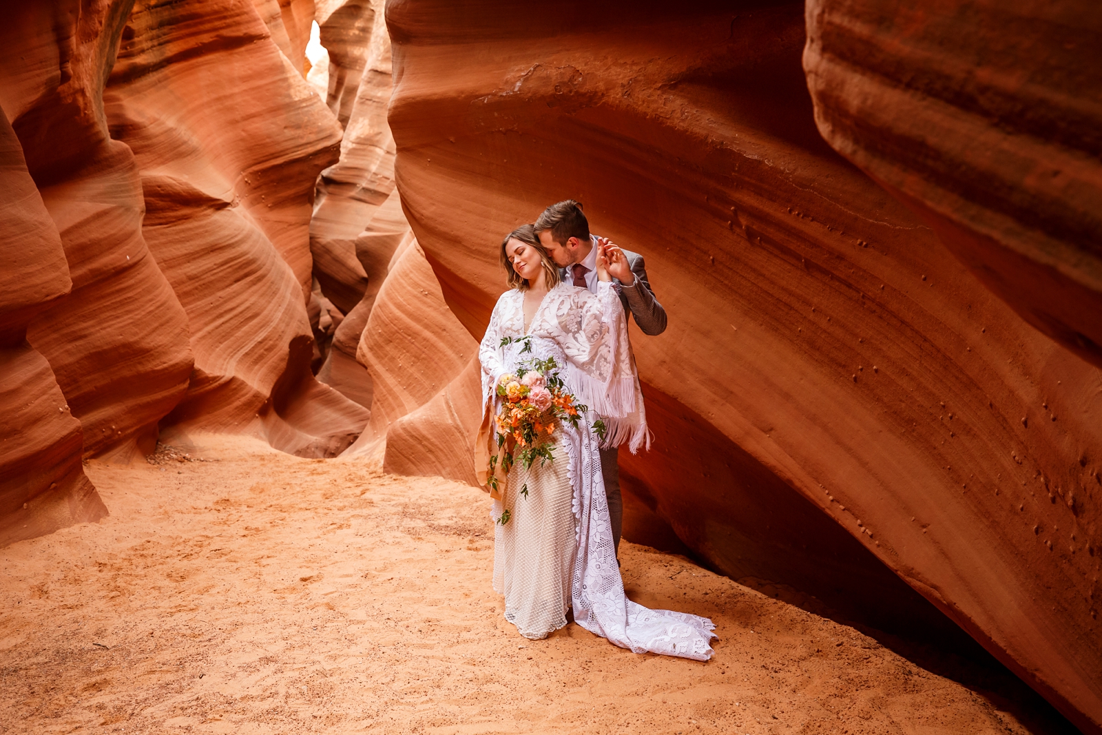 A fun boho couple enjoying their slot canyon elopement in Waterholes Canyon near Horseshoe Bend in Page Arizona