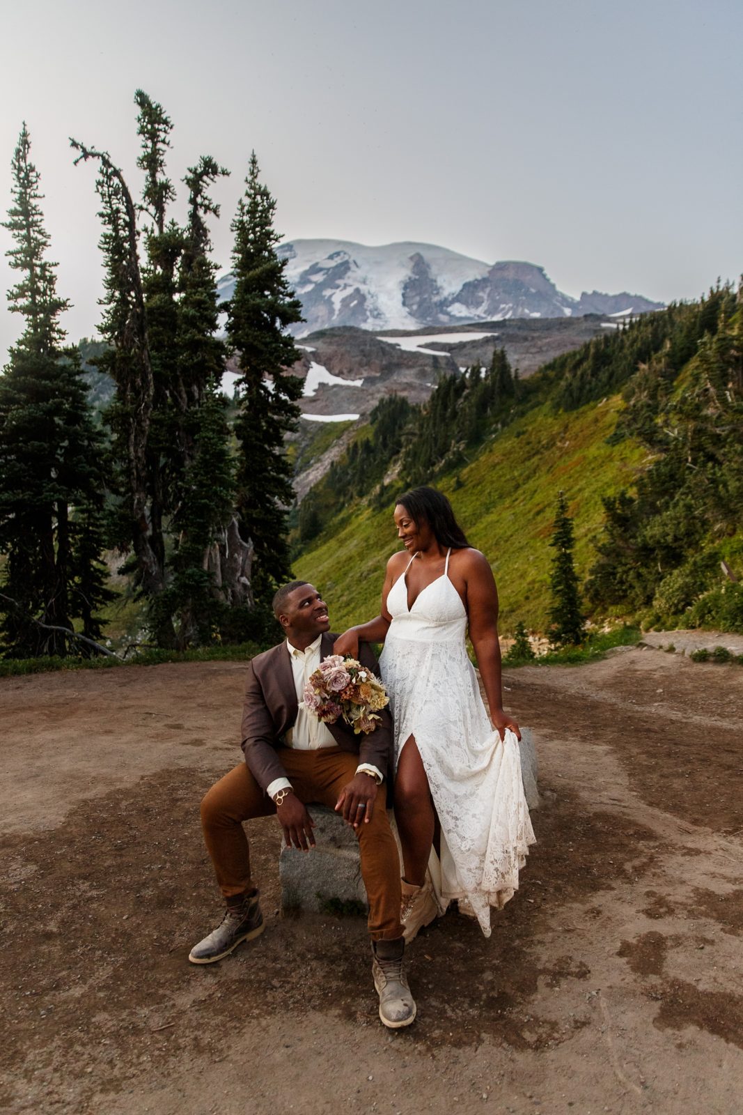 Fun couple laugh with each other during their hiking elopement adventure at Mount Rainier.