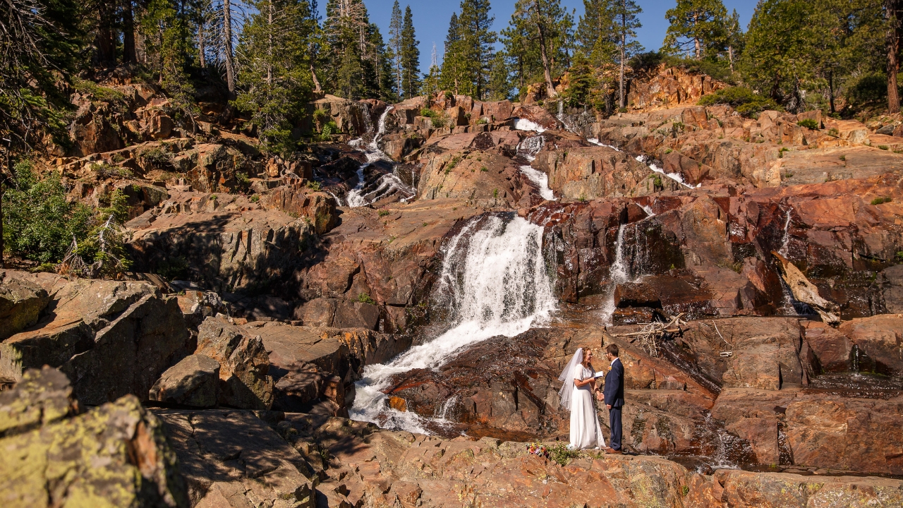 Photo of couple exchanging vows at a waterfall at Lake Tahoe