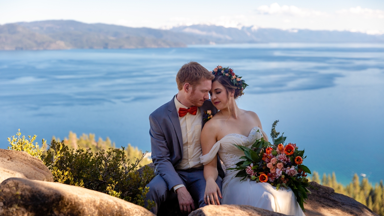 photo of bride and groom resting foreheads on each other with Lake Tahoe