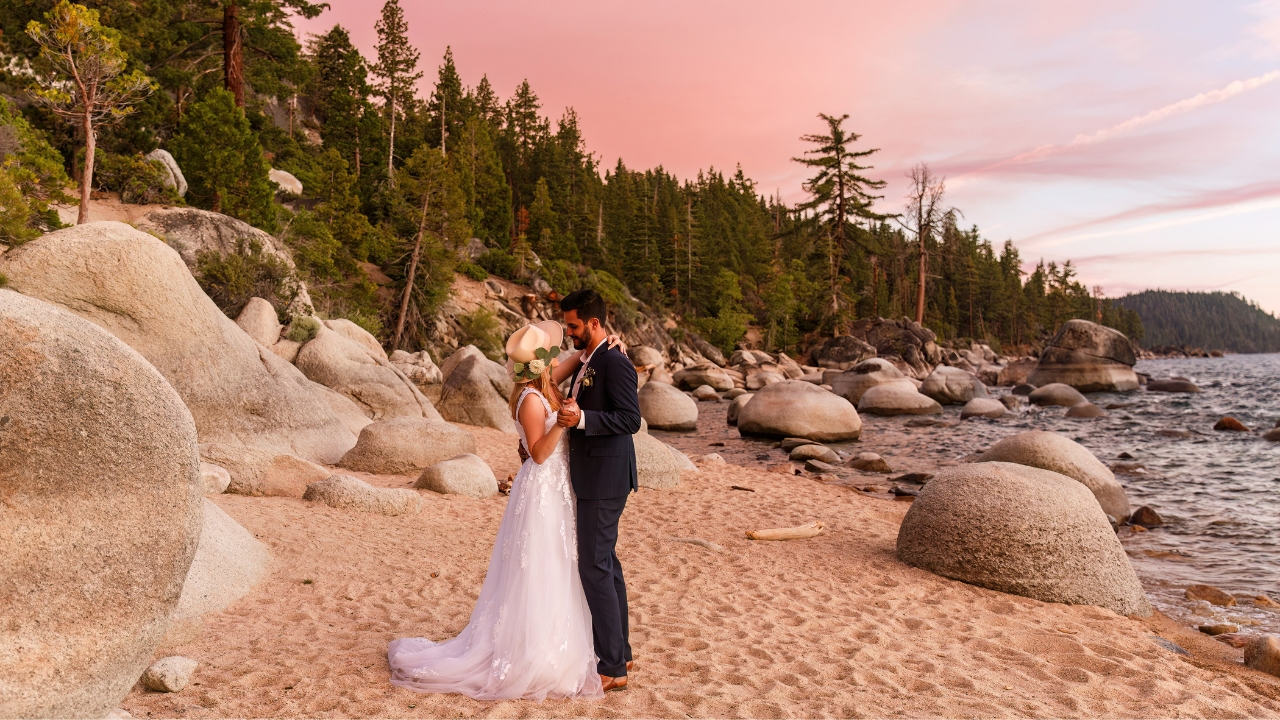 Photo of bride and groom dancing on the beach at sunset for their Lake Tahoe elopement
