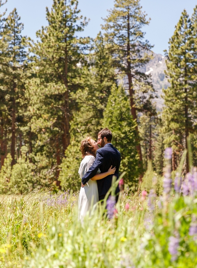 photo of bride and groom kissing in a field of wildflowers at Lake Tahoe