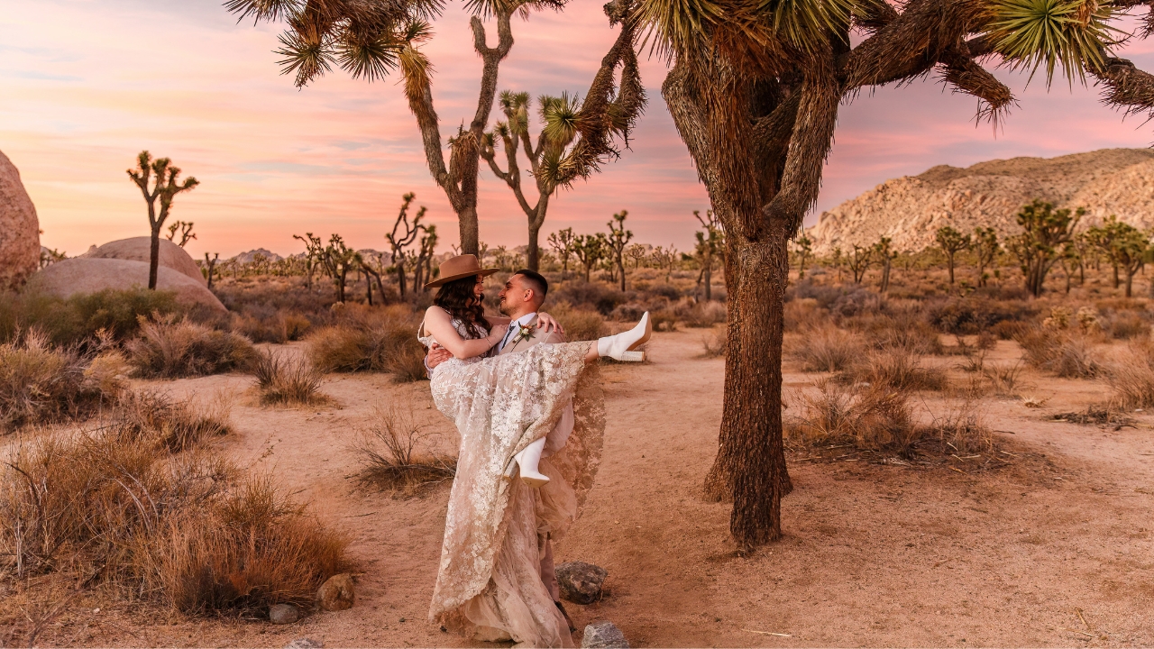 photo of groom holding bride up in the air at sunset for their Joshua Tree elopement