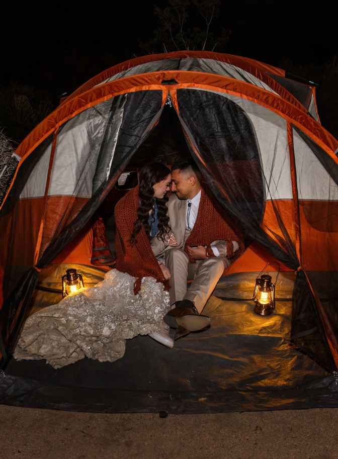 photo of bride and groom snuggling in tent for their wedding night at Joshua Tree