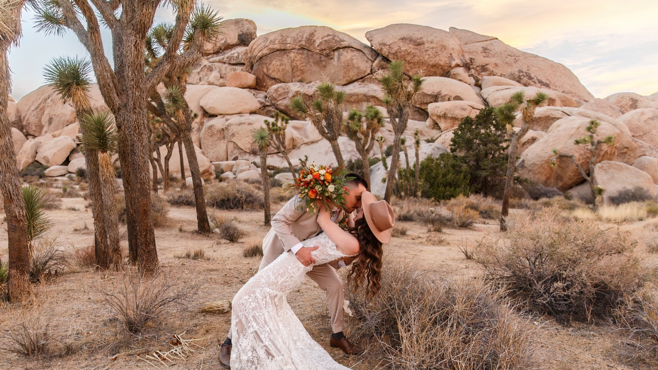 photo of groom dipping his bride and kissing her for their elopement at Joshua Tree