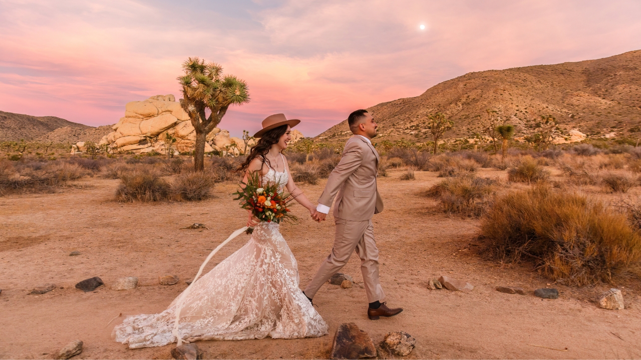 photo of bride and groom walking hand and hand at Joshua Tree for their adventure elopement