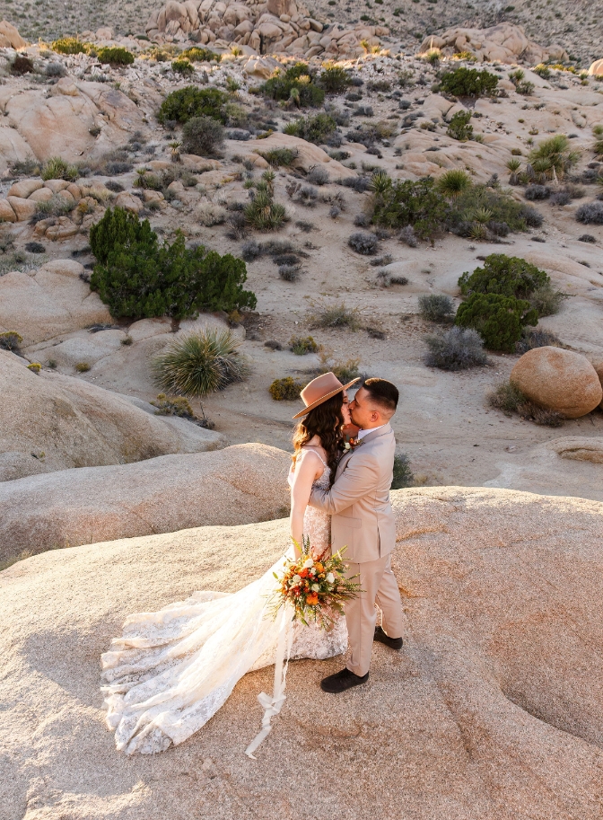 photo of bride and groom kissing on wedding day in Joshua Tree