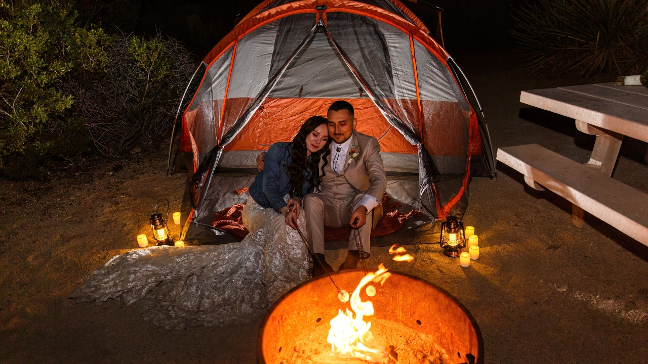 photo of bride and groom in tent making smores at Joshua Tree