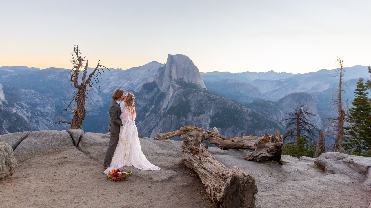 photo of bride and groom kissing at Yosemite National Park at sunrise