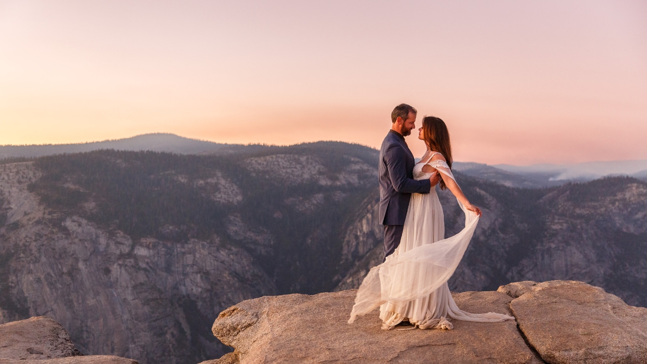 photo of bride and groom at sunrise with Sierra Nevada Mountains behind them