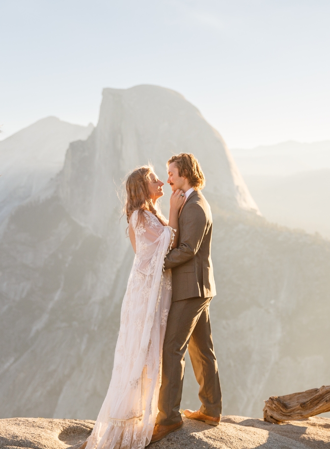 photo of bride caressing grooms face at sunrise in Yosemite