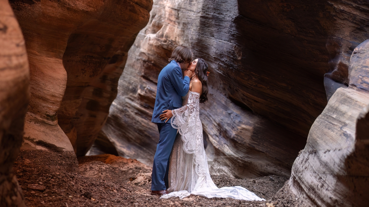 photo of bride and groom kissing in Utah slot canyon on wedding day