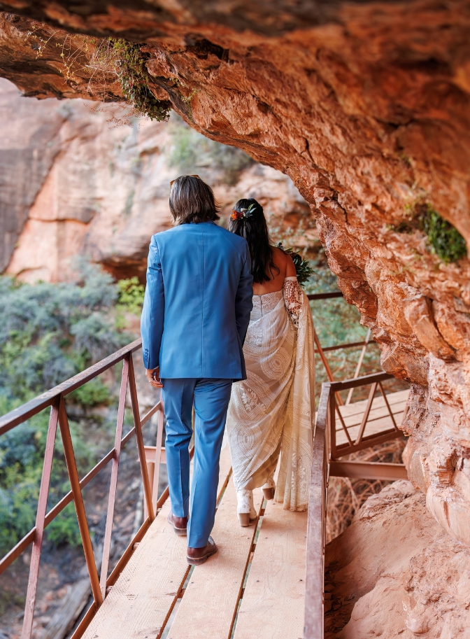 photo of bride and groom walking across bridge at Zion National Park