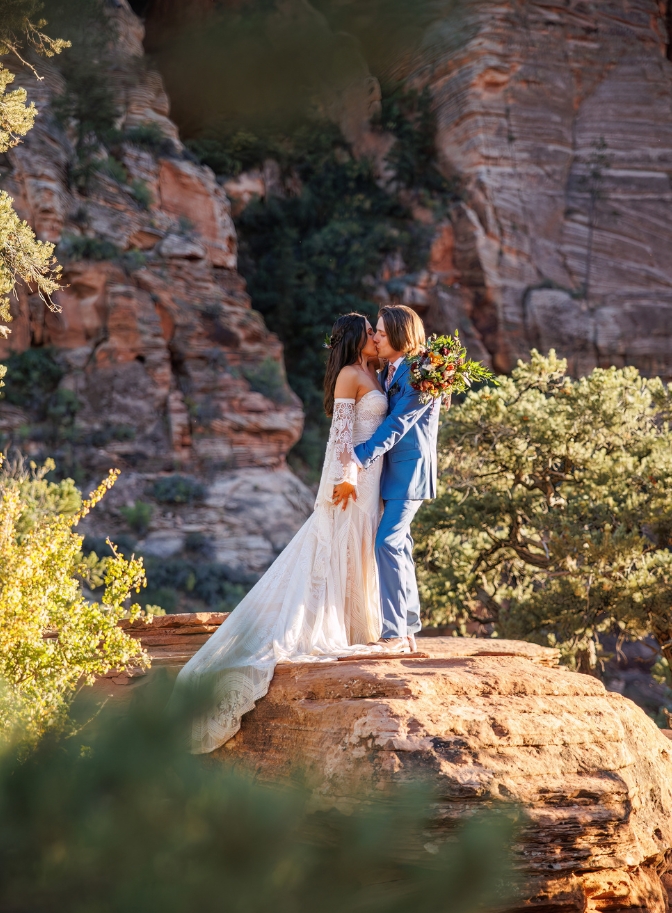 photo of bride and groom kissing on a rock for their Zion elopement