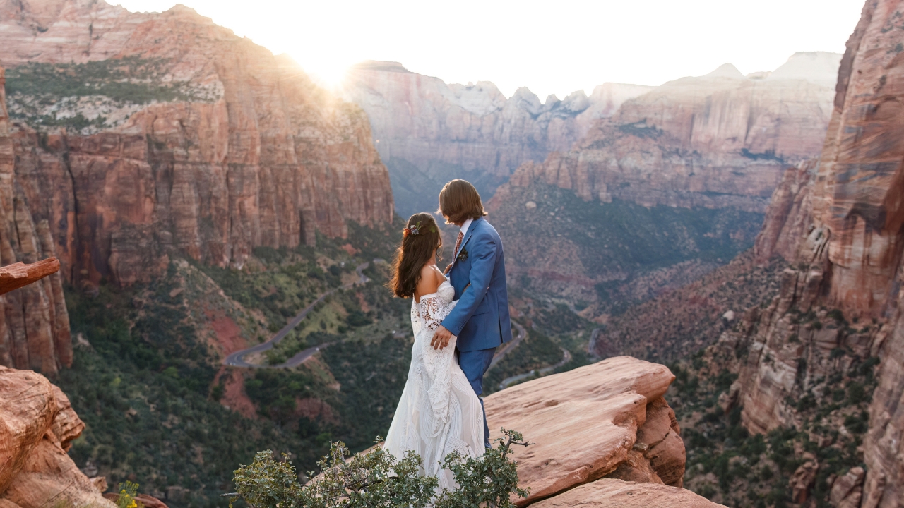 photo of bride and groom looking out at Zion Valley