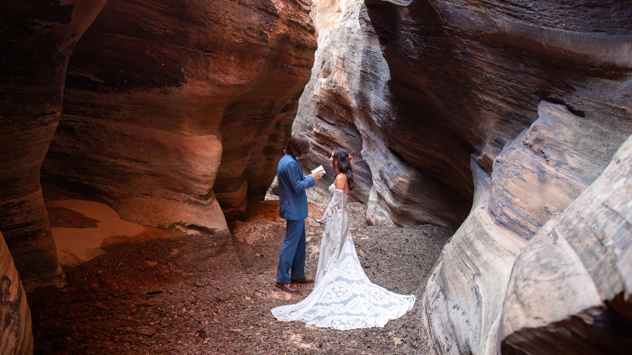 photo of bride and groom exchanging private vows for their Zion elopement in a slot canyon