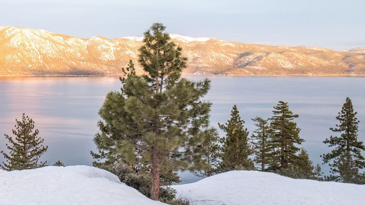 photo of mountains in the background covered in snow at Lake Tahoe