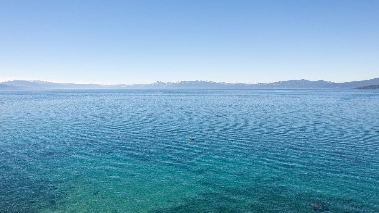 photo of boat floating in the water at Lake Tahoe for engagement shoot