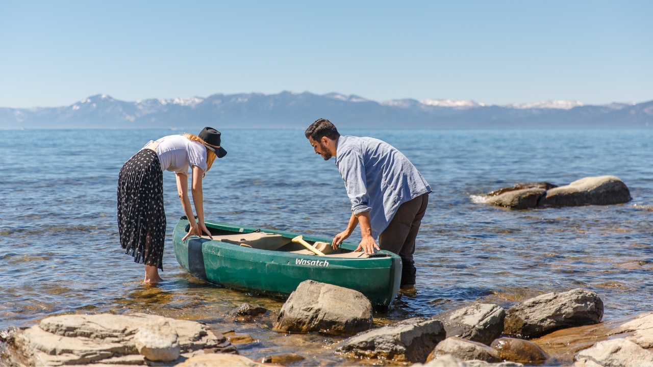 photo of couple pulling canoe into the water at Lake Tahoe