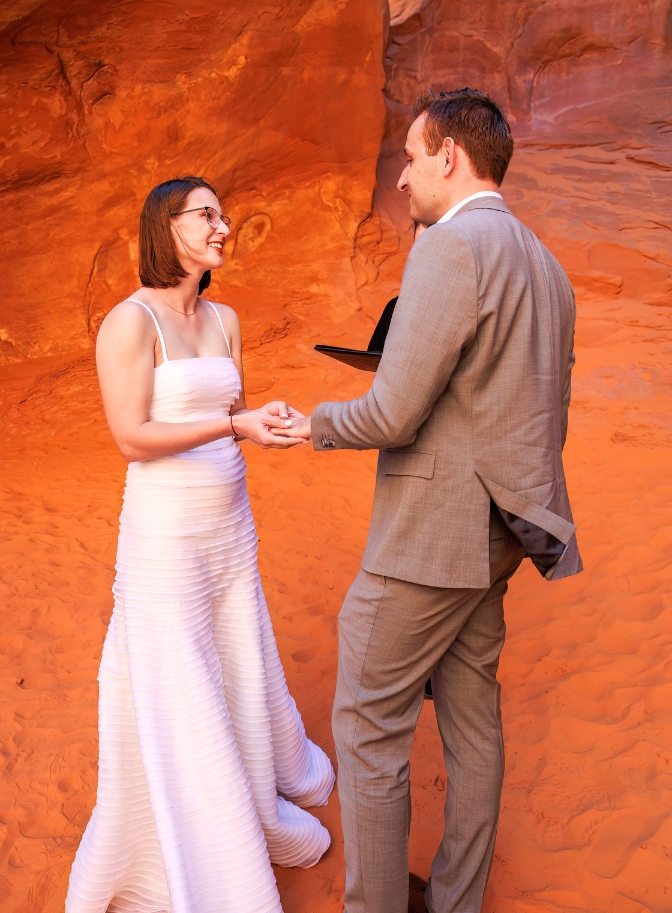 photo of bride and groom holding hands as they exchange vows