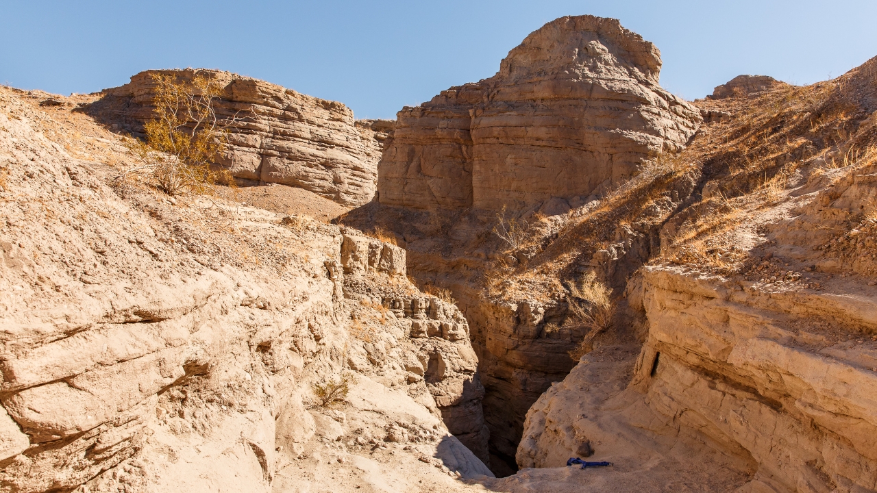 photo of rockface above a slot canyon