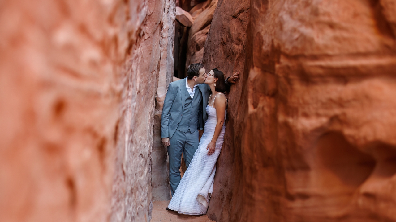 photo of bride and groom kissing in a slot canyon in Arches National Park