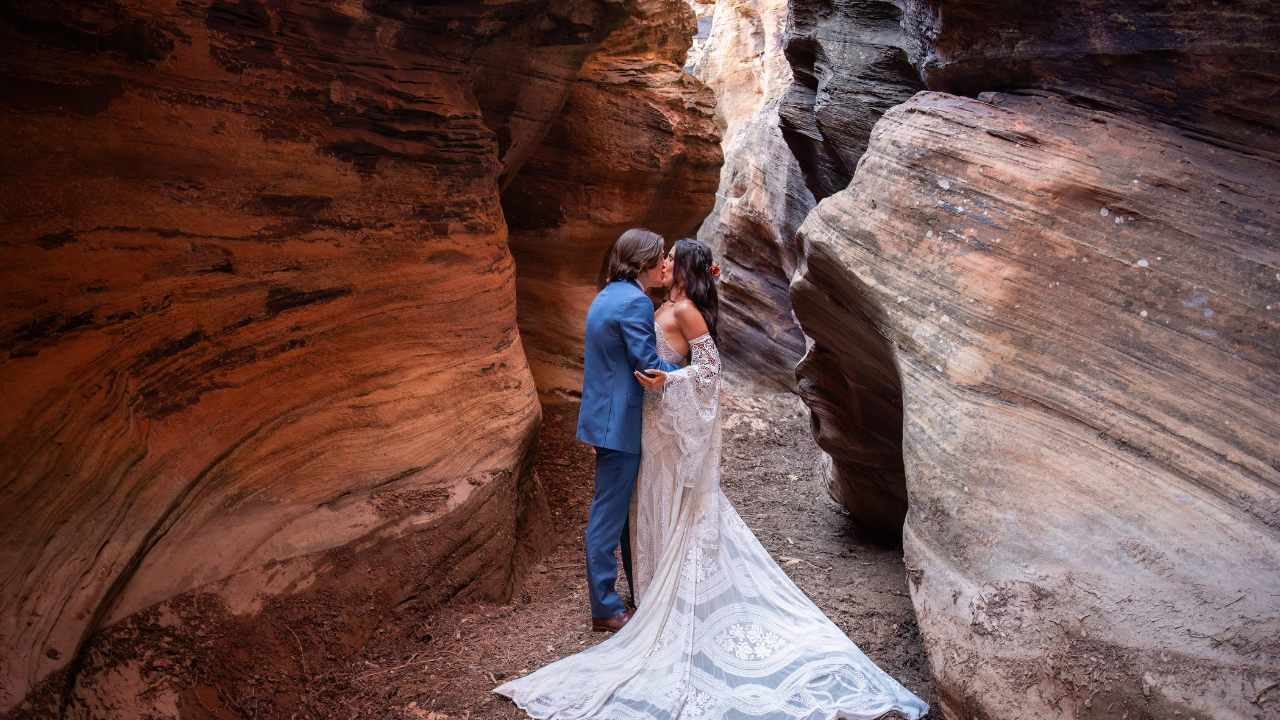 photo of bride and groom kissing in a slot canyon in Zion National Park