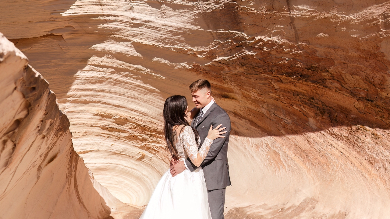 photo of bride and groom staring into each other eyes along side a slot canyon near Horseshoe Bend