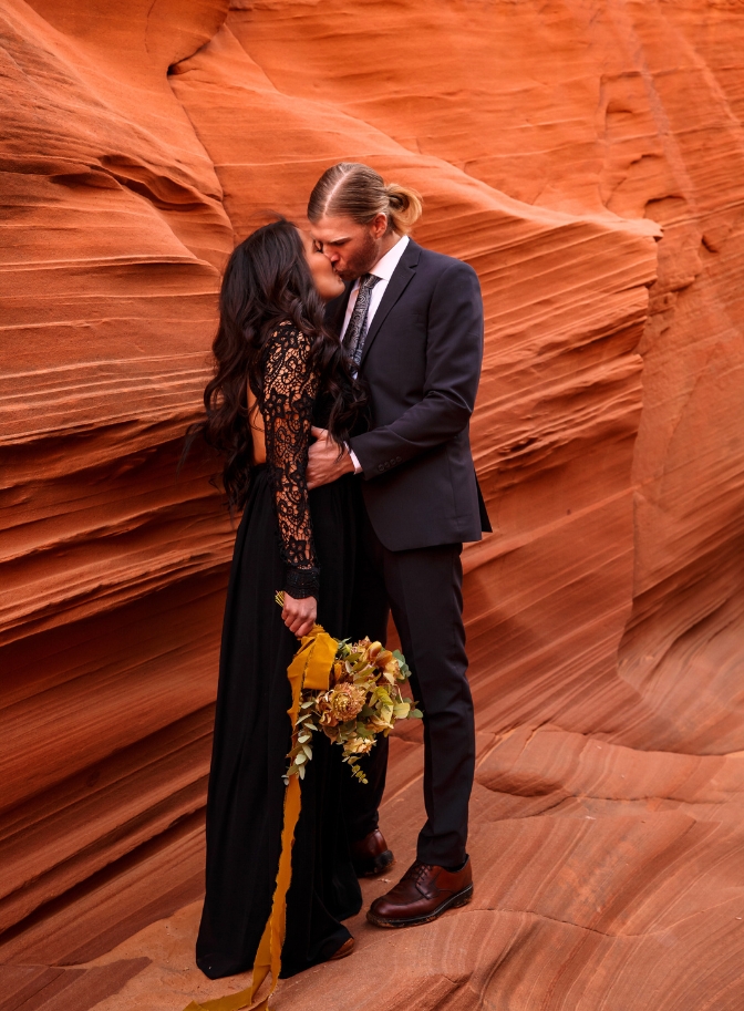 photo of bride and groom kissing in a slot canyon for their elopement