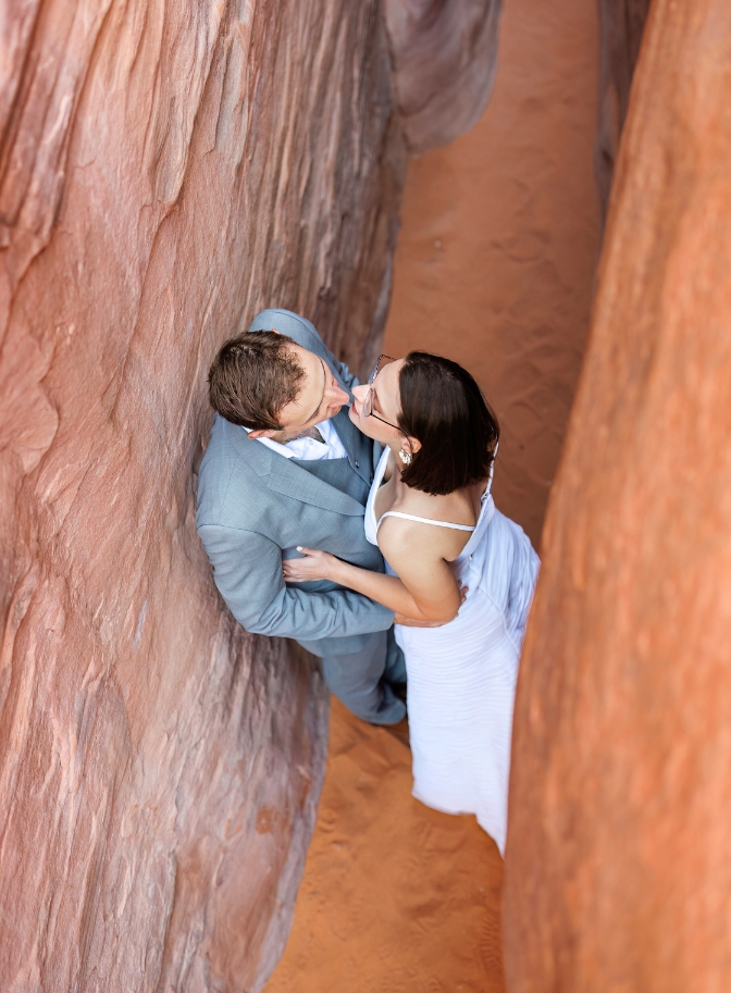 photo of bride and groom kissing in between slot canyon