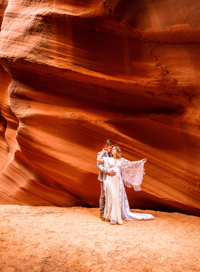 photo of bride and groom embracing at Waterholes Canyon