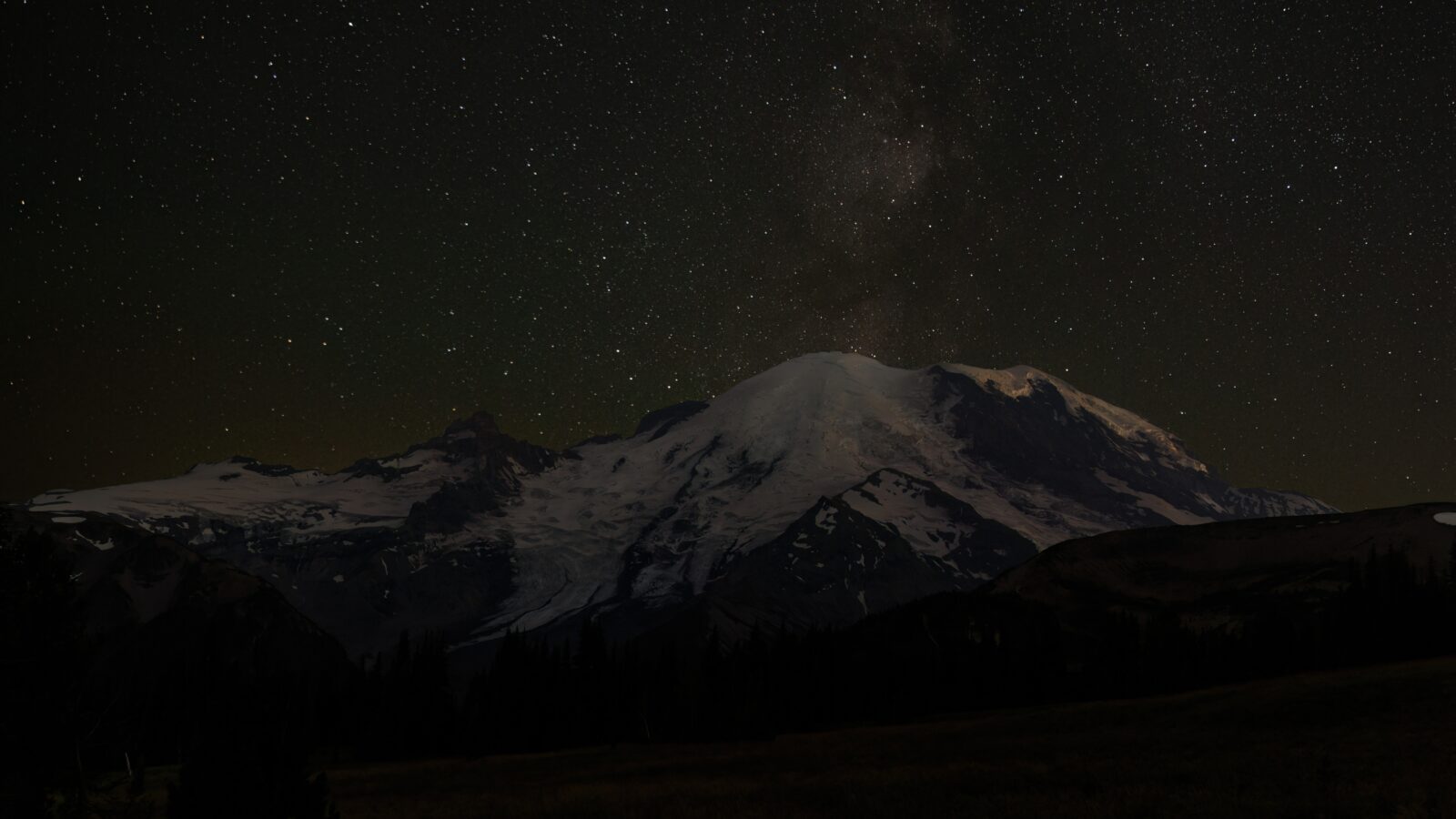 photo of Sunrise Mountain at night with stars in the distance