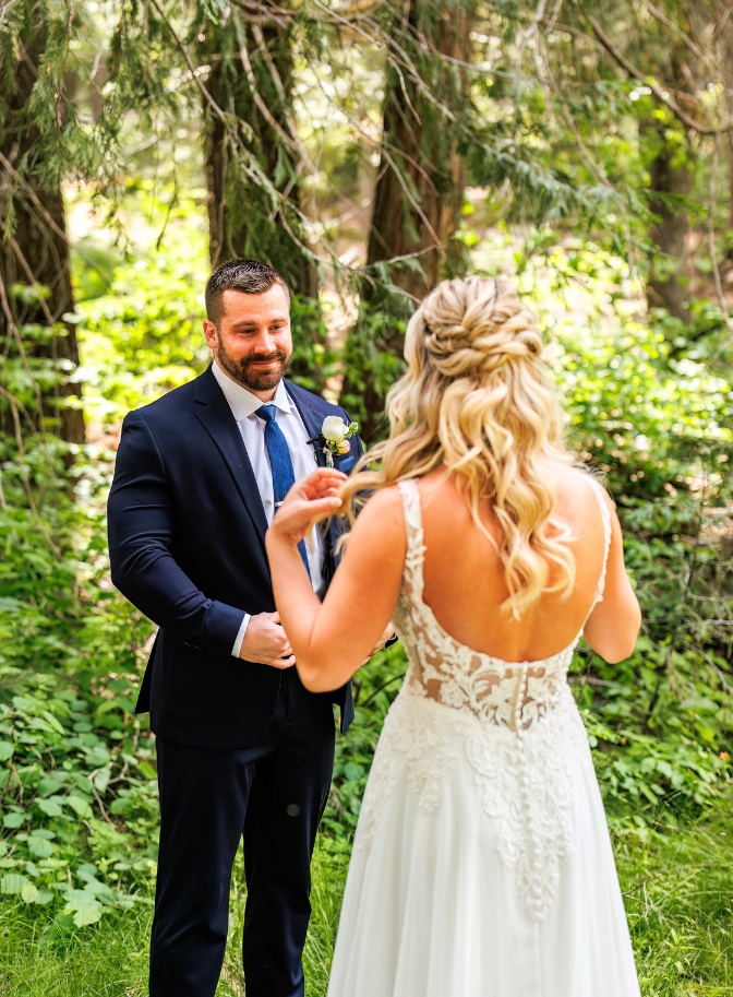 photo of groom looking at bride with tears in his eyes during first look