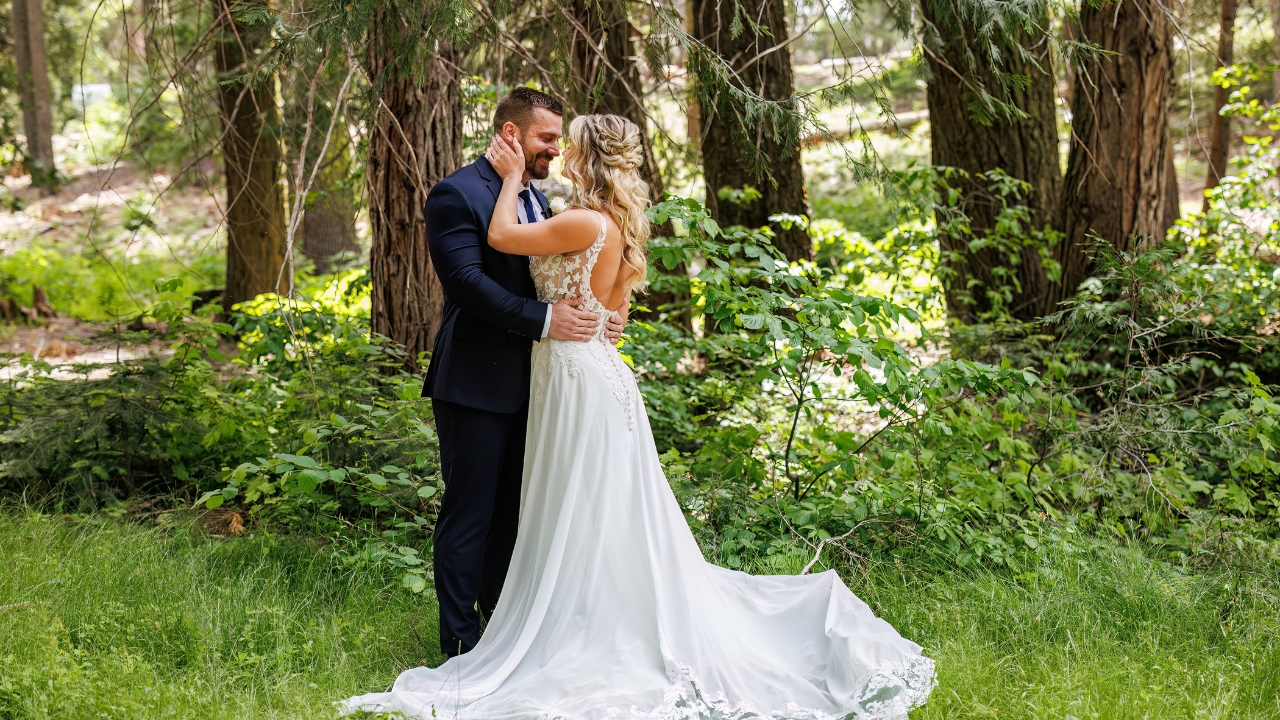 photo of bride and groom staring into each others eyes as they embrace and she holds his face