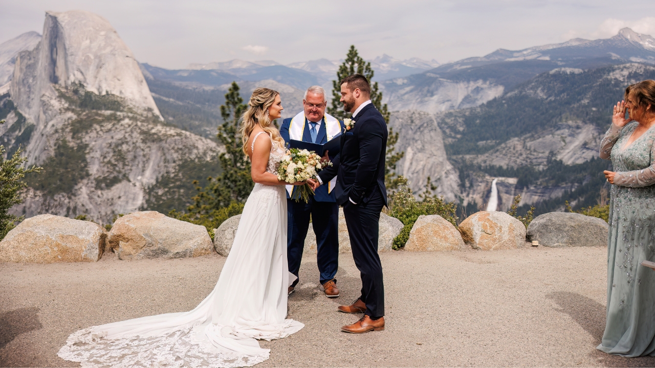 photo of bride and groom standing at Glacier Point for their Yosemite wedding ceremony