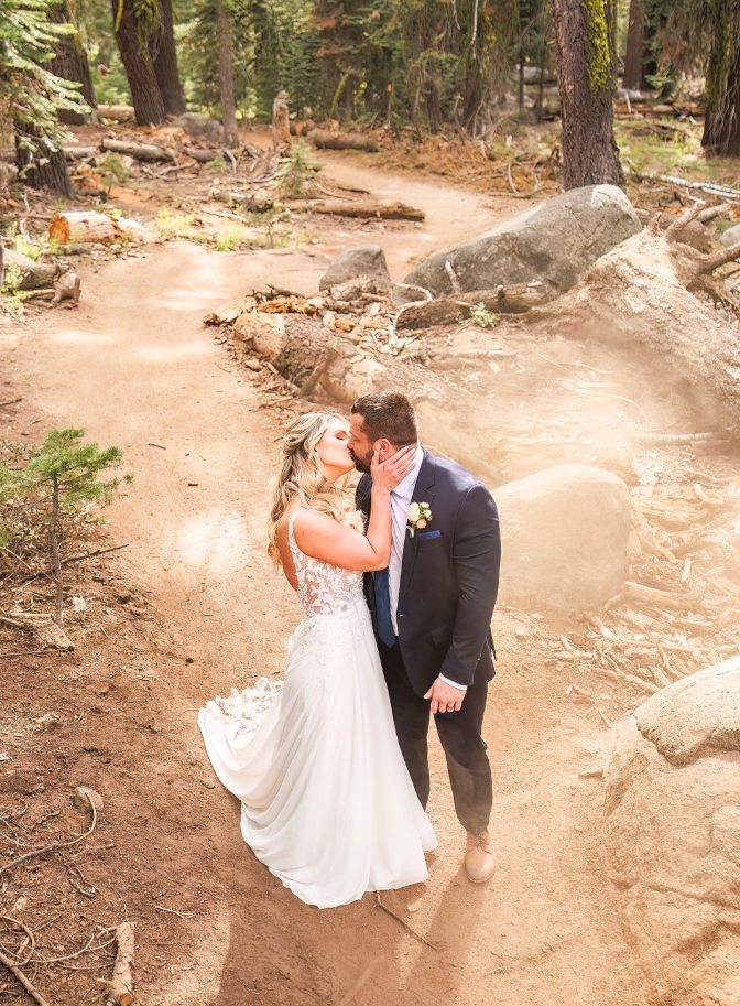 photo of bride and groom kissing in the woods at Yosemite