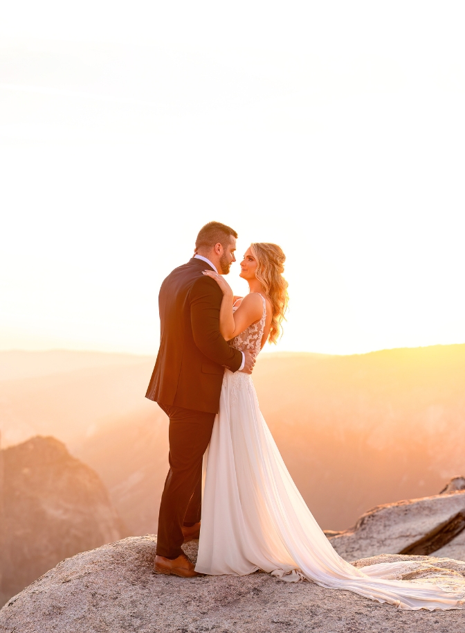 photo of bride and groom holding each other and staring into each other's eyes on wedding day