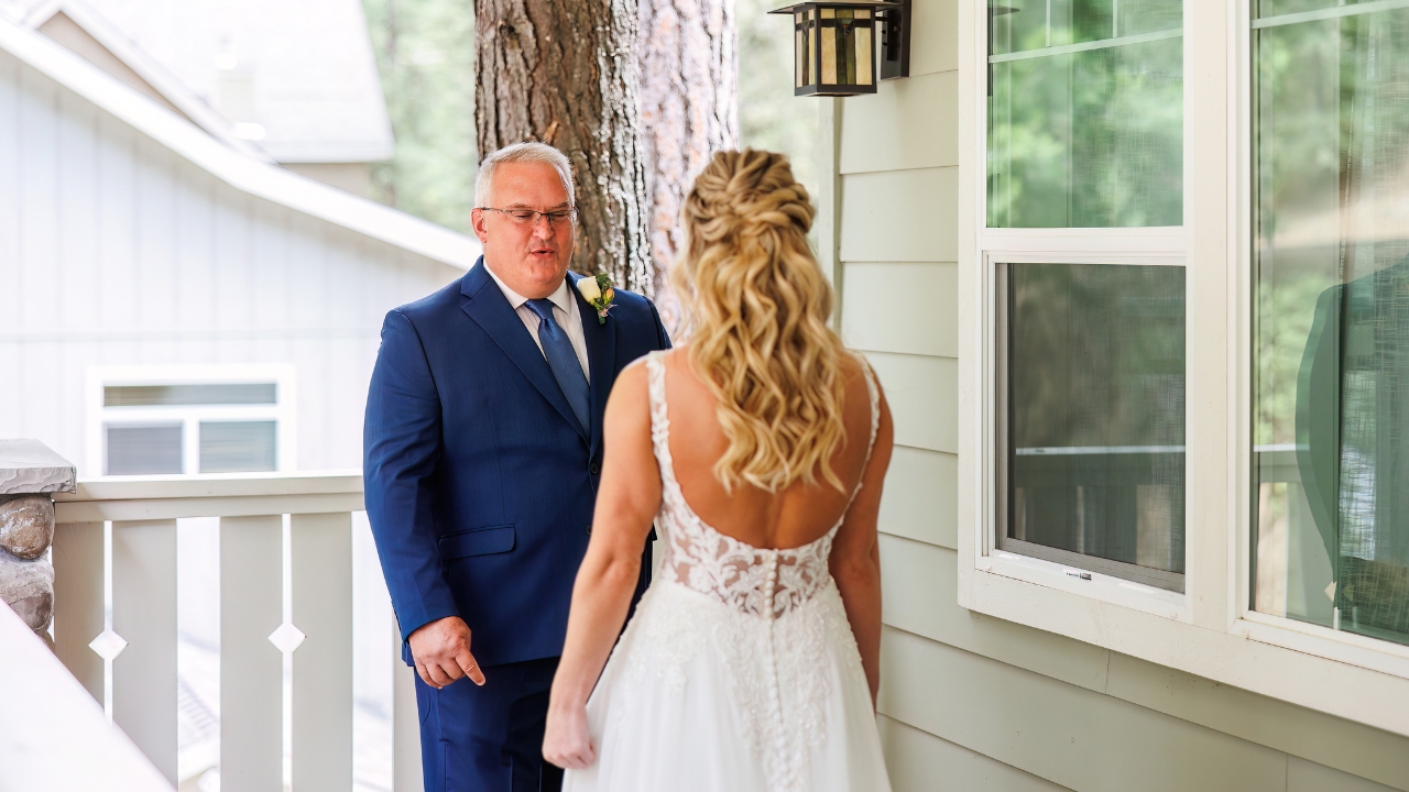 photo of father having first look with daughter on wedding day on porch