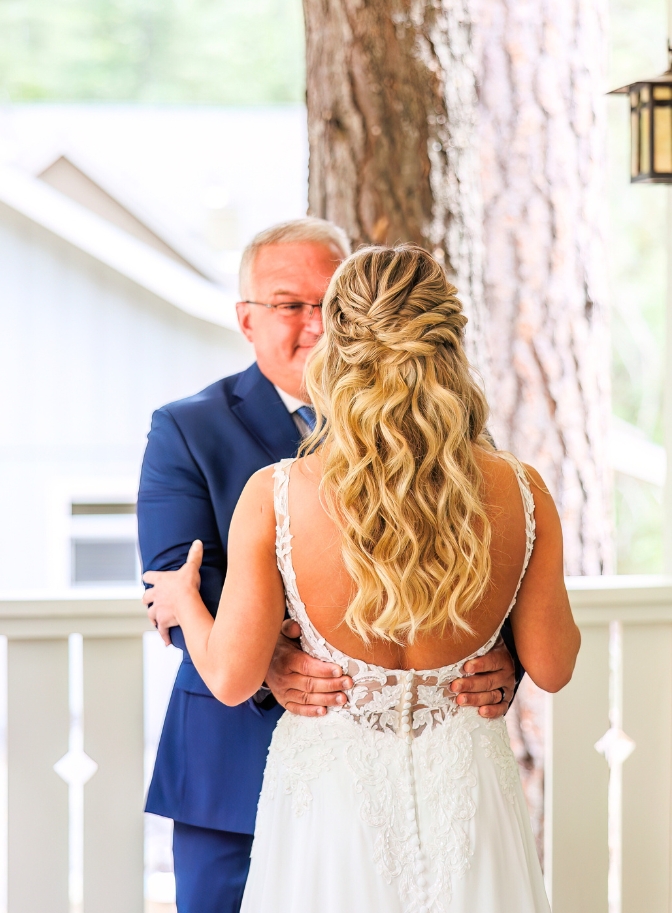 photo of father and daughter embracing as he's emotional for their first look