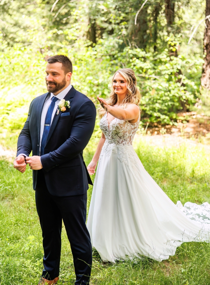 photo of bride tapping groom on the shoulder for first look