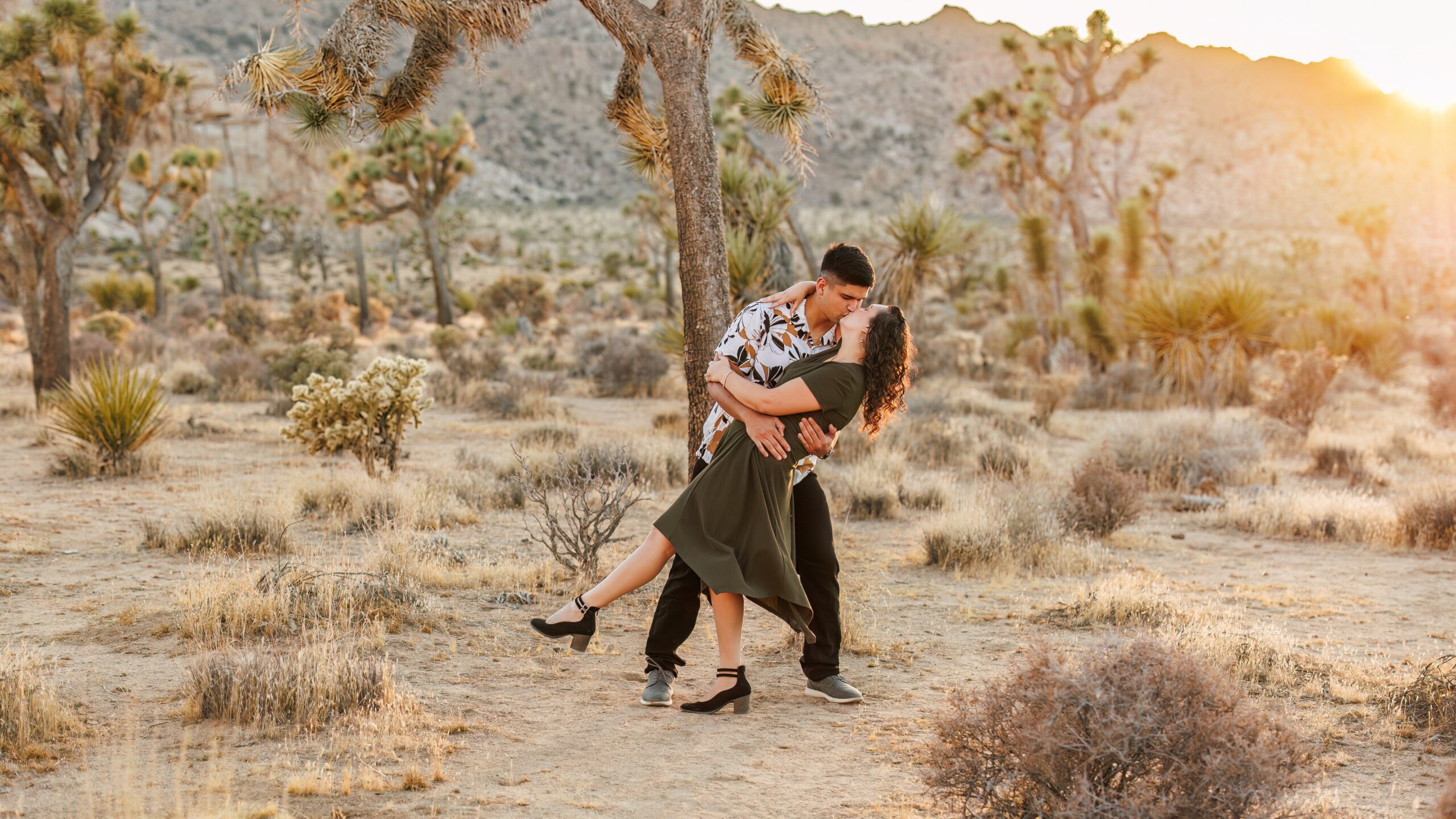 photo of guy dipping fiancée and kissing in Joshua Tree