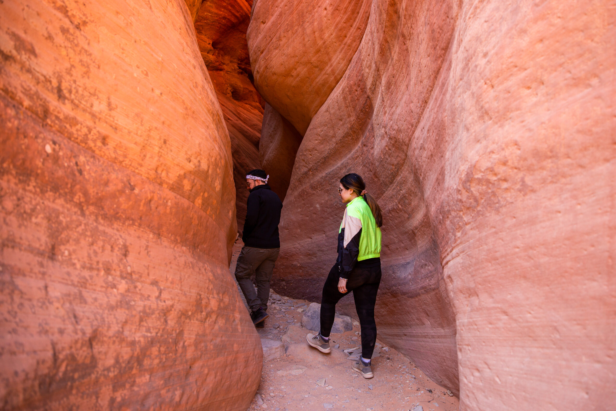 a couple walking through the canyons on an adventure 