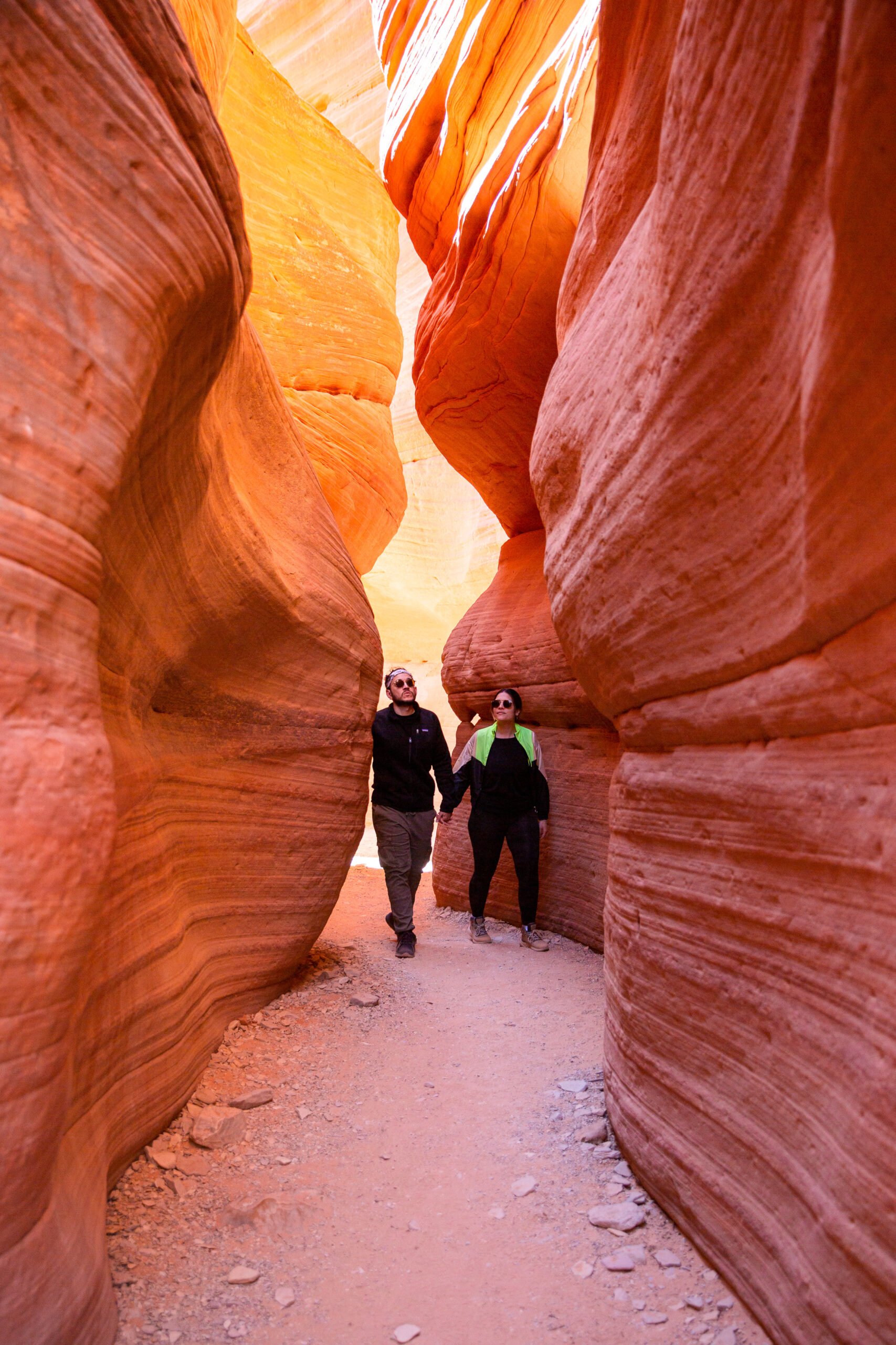 a couple walking hand in hand through the canyons after months of research on how to plan the perfect proposal