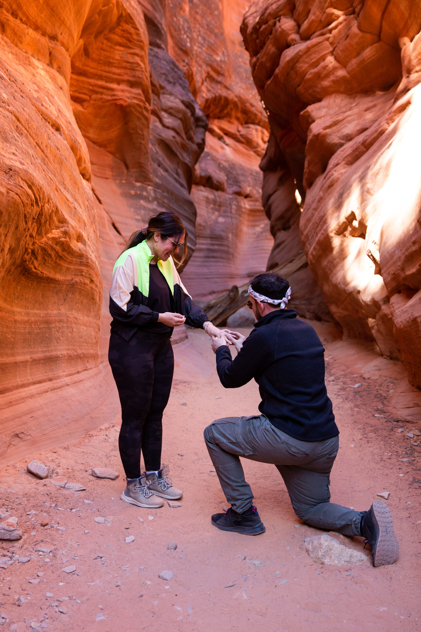 a man on one knee proposing after months of planning how to plan the proposal